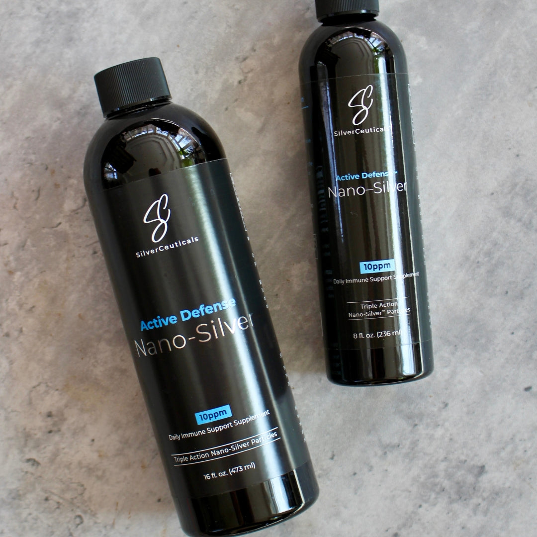 Two bottles of SilverCeuticals Active Defense Nano-Silver 10ppm, one 16oz and one 8oz,  on a gray surface.